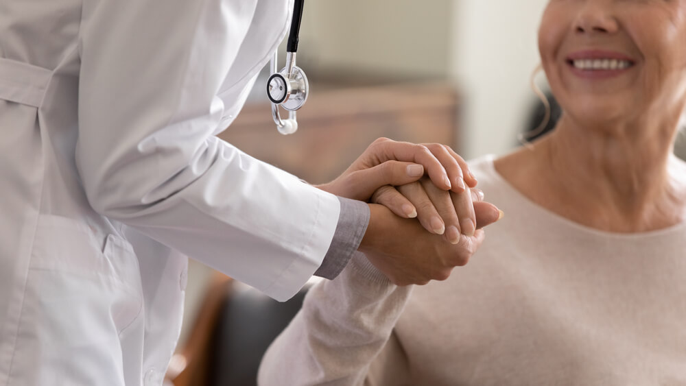 dr holding patient hand